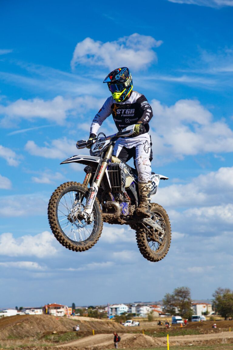 Helmeted rider catching air during a race