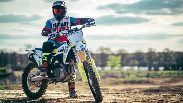 Motocross racer in full gear riding outdoors