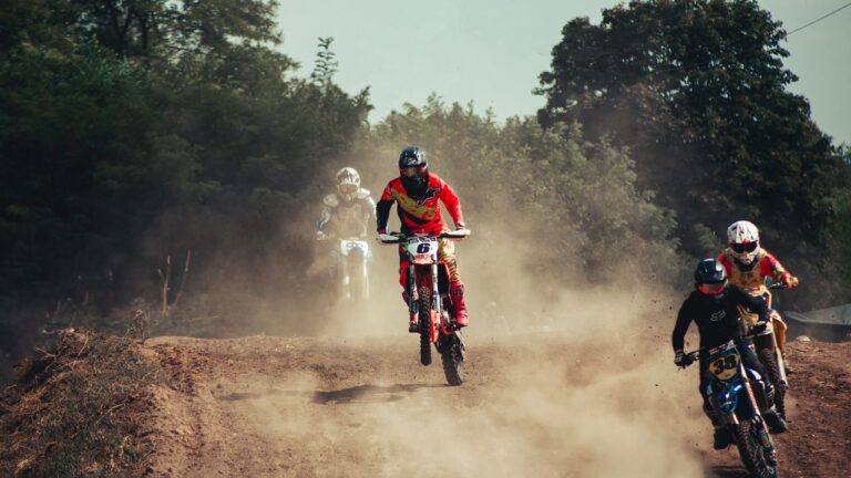 Motocross race action on a dusty track