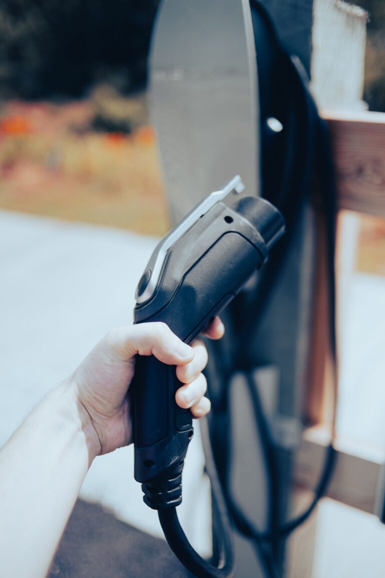 Hand holding an EV charging cable