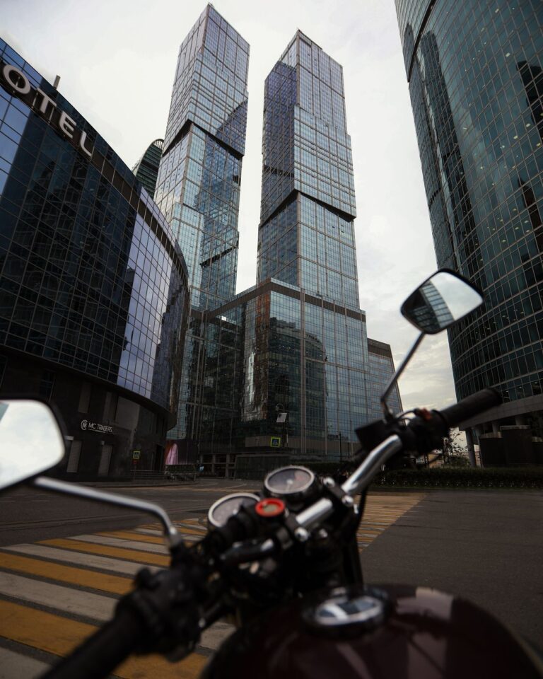 Motorbike parked in front of city skyscrapers