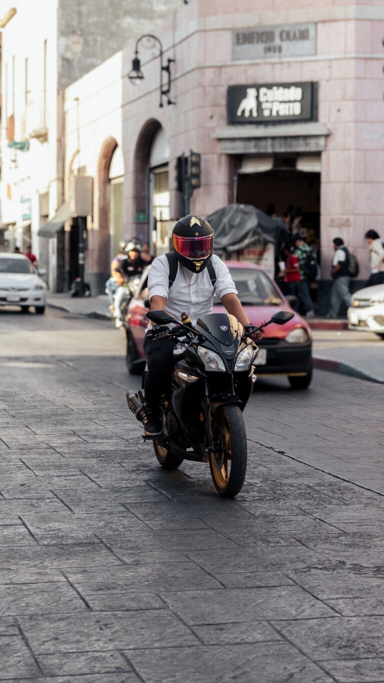 Motorcyclist riding through city traffic