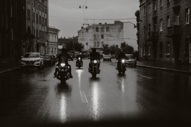 Motorcyclists riding at night in the rain