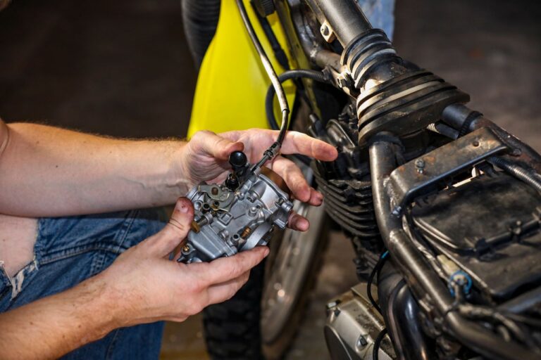Hands working on motorcycle components