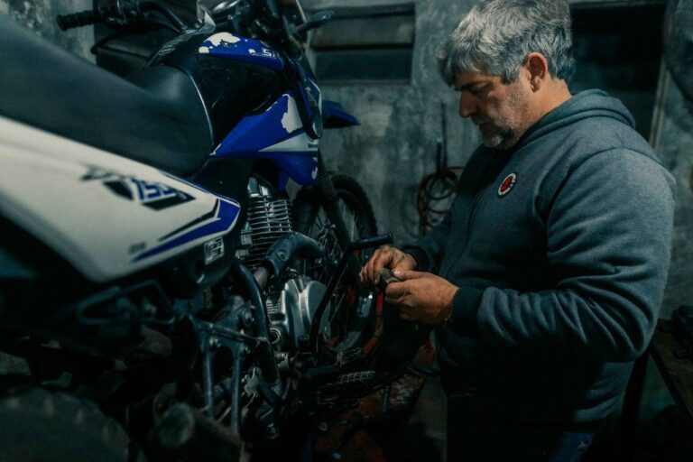 Mechanic repairing a motorcycle in a garage
