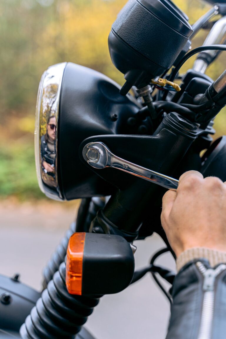 Hand tightening bolts on a motorcycle