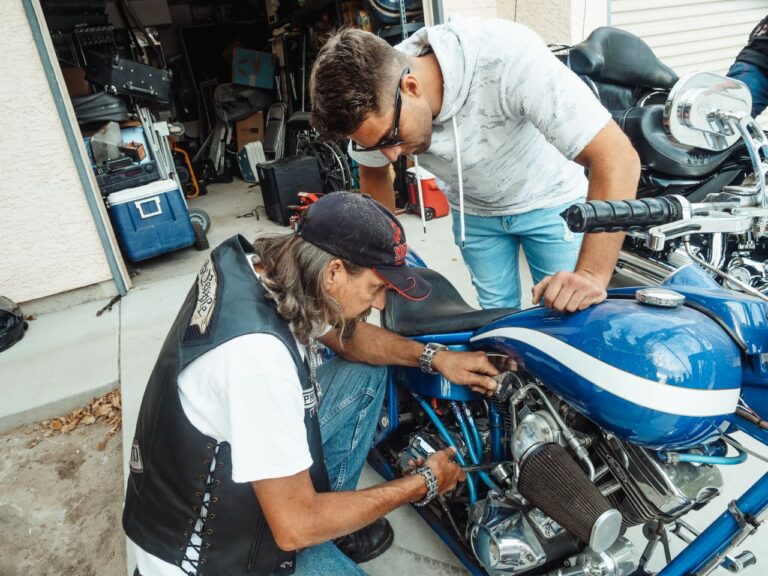 Two people working on a motorcycle together
